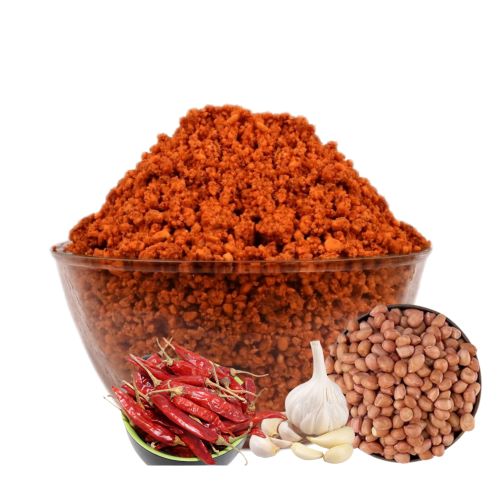A bowl of dry peanut chutney with peanuts, garlic and red chillies